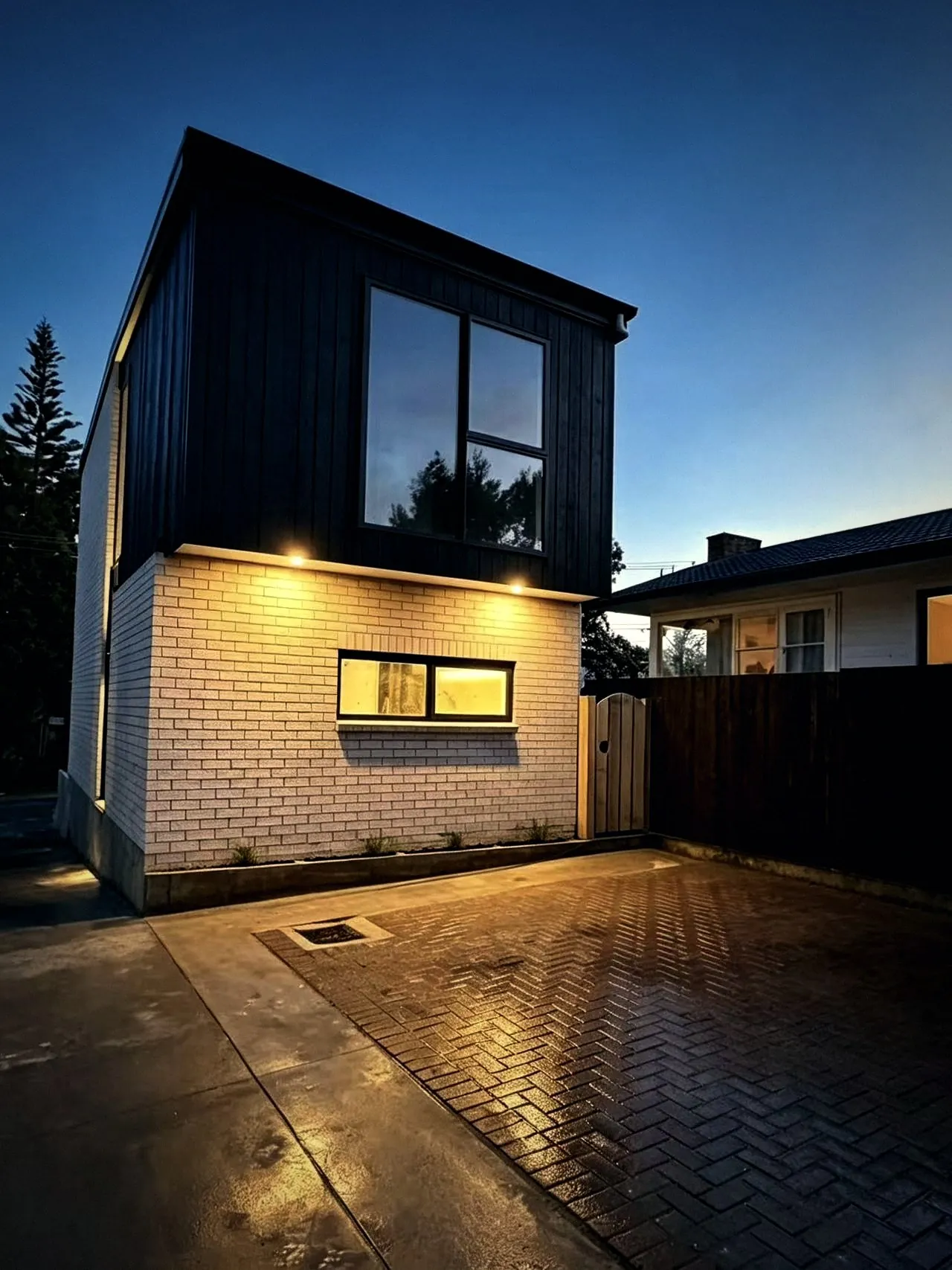 Townhouse with herringbone paved courtyard at dusk