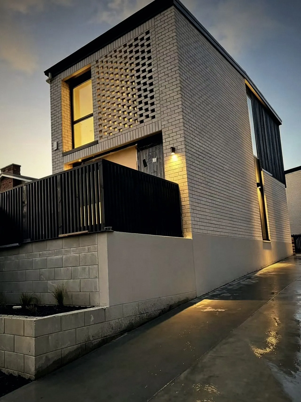 Brick townhouse with feature breeze-block screen